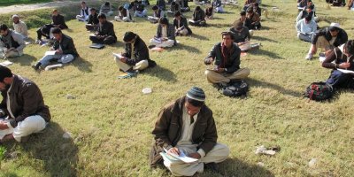First-year students taking a test outside the classroom at Nangarhar University in Afghanistan (2011).
